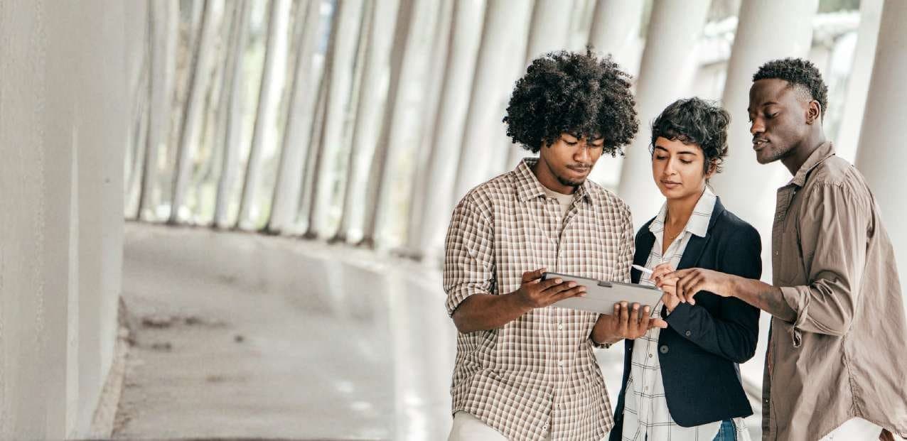 Three people reviewing a plan together