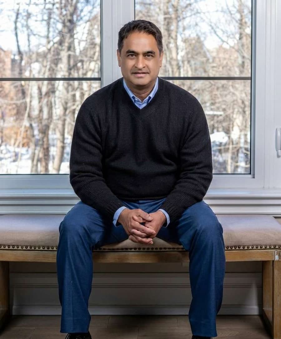 Shamenav Khan seated by a window